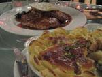 Potato and Bacalhau pie and bife com um ovo a cavalo in the background