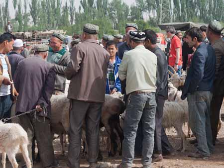 Men bartering around the goats